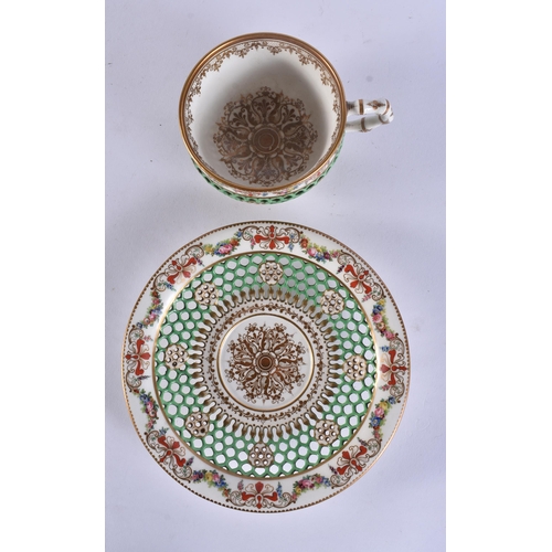 152 - A LOVELY 19TH CENTURY WORCESTER RETICULATED CUP AND SAUCER painted with flowers. 13 cm wide. (2)