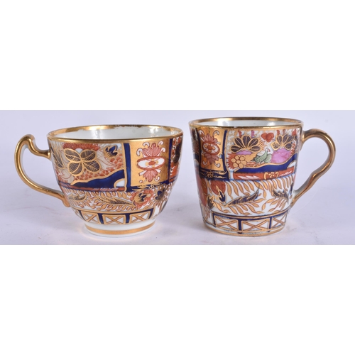 56 - AN EARLY 19TH CENTURY CHAMBERLAINS WORCESTER TRIO painted with imari gardens. 12 cm wide. (3)