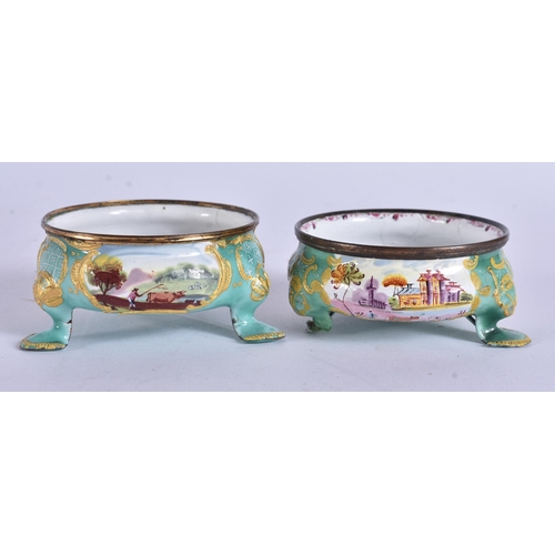 5 - AN UNUSUAL PAIR OF 18TH CENTURY BATTERSEA ENAMEL SALTS painted with landscapes. 7 cm wide.