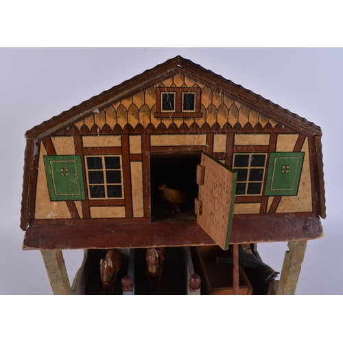 111 - AN UNUSUAL ANTIQUE FOLK ART PAINTED WOOD HORSE STABLES with horses and cart. 40 cm x 25 cm.