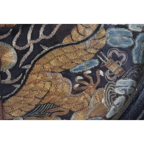 116 - A CHINESE QING DYNASTY SILK EMBROIDERED DRAGON RANK BADGE. 31.5 cm wide.
