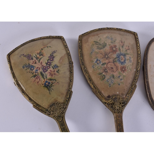 12 - FIVE VINTAGE EMBROIDERED GILT METAL VANITY MIRRORS. 38 cm long. (5)