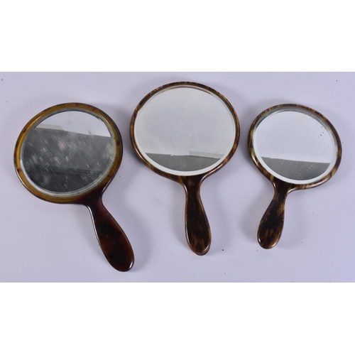 13 - THREE VINTAGE FAUX TORTOISESHELL VANITY MIRRORS. 34 cm long. (3)