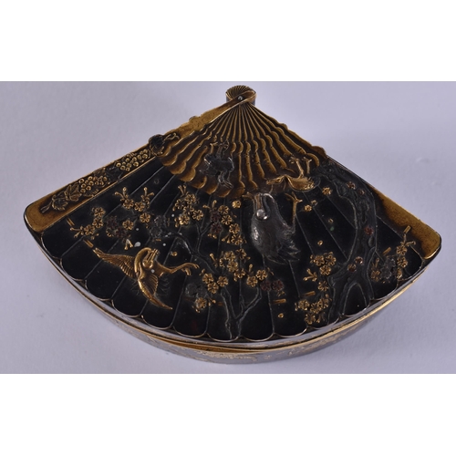 155 - A 19TH CENTURY JAPANESE MEIJI PERIOD BRONZE GOLD ONLAID FAN SHAPED BOX decorated with birds amongst ... 