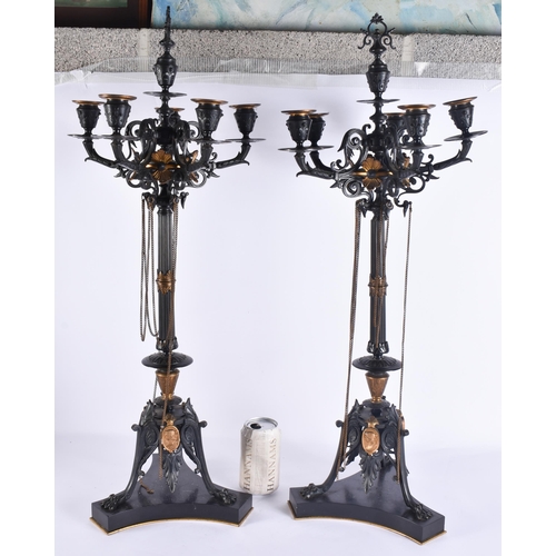 160A - A LARGE PAIR OF 19TH CENTURY FRENCH BRONZE AND GILT BRONZE CANDLESTICKS formed with classical mask h... 