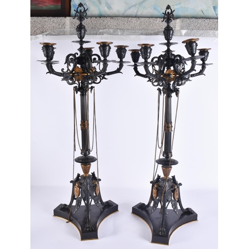 160A - A LARGE PAIR OF 19TH CENTURY FRENCH BRONZE AND GILT BRONZE CANDLESTICKS formed with classical mask h... 
