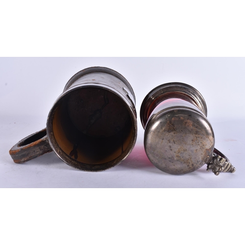 200E - AN ANTIQUE SILVER MOUNTED LEATHER TANKARD together with a smaller silver plated ruby glass tankard. ... 
