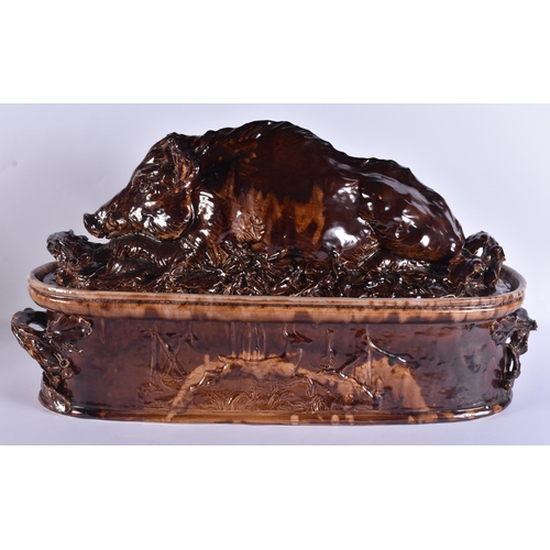 20G - A RARE LARGE 19TH CENTURY CONTINENTAL TREACLE GLAZED GAME TUREEN AND COVER formed with a large wild ... 
