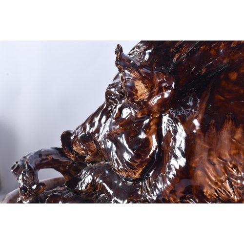 20G - A RARE LARGE 19TH CENTURY CONTINENTAL TREACLE GLAZED GAME TUREEN AND COVER formed with a large wild ... 