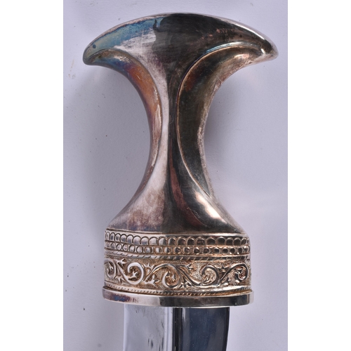 23 - A MIDDLE EASTERN OMANI SILVER CASED JAMBIYA DAGGER. 697 grams overall. 28 cm x 16 cm.