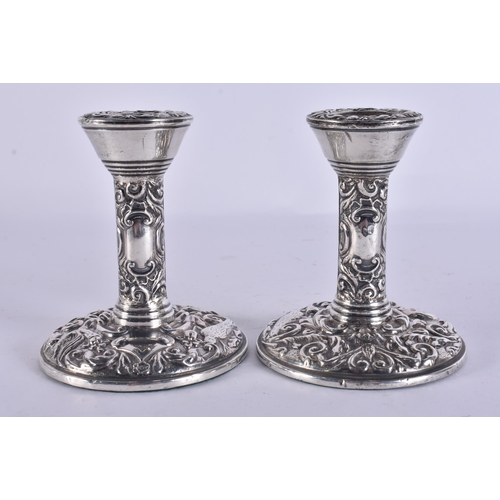 255 - A PAIR OF SILVER CANDLESTICKS. 310 grams overall. 10.5 cm high.