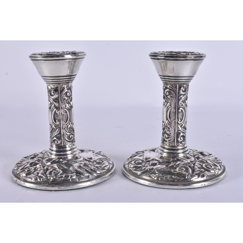 255 - A PAIR OF SILVER CANDLESTICKS. 310 grams overall. 10.5 cm high.