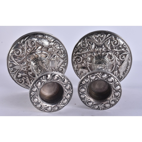 255 - A PAIR OF SILVER CANDLESTICKS. 310 grams overall. 10.5 cm high.