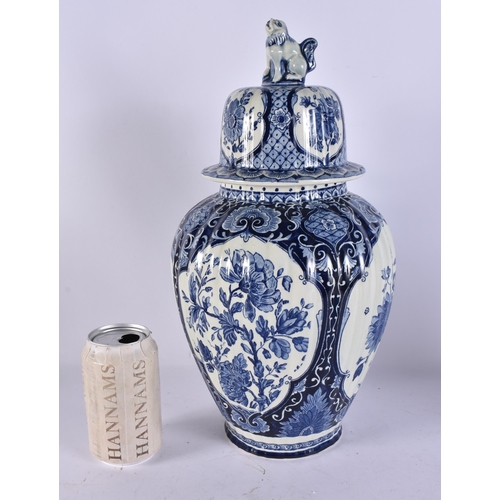317A - A DUTCH DELFT BLUE AND WHITE POTTERY VASE AND COVER. 39 cm high.