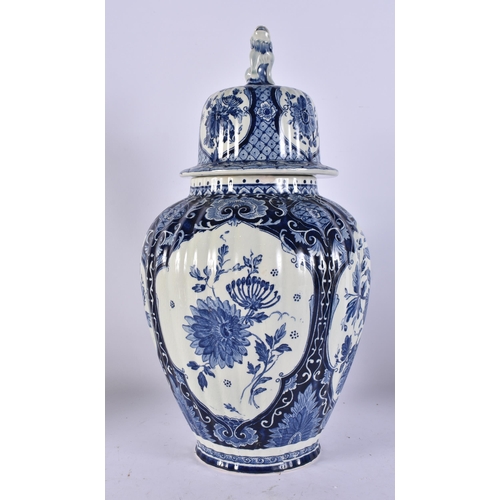 317A - A DUTCH DELFT BLUE AND WHITE POTTERY VASE AND COVER. 39 cm high.