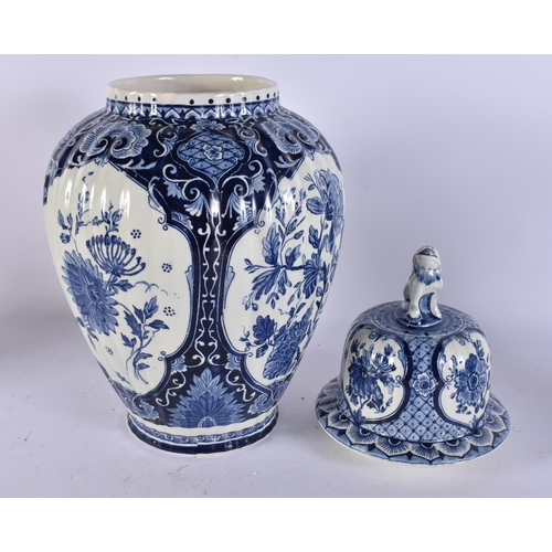 317A - A DUTCH DELFT BLUE AND WHITE POTTERY VASE AND COVER. 39 cm high.