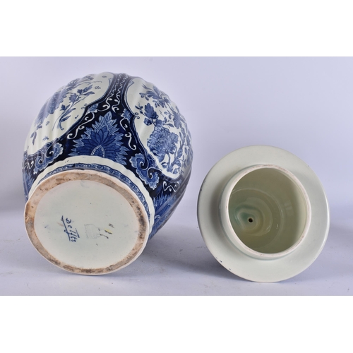 317A - A DUTCH DELFT BLUE AND WHITE POTTERY VASE AND COVER. 39 cm high.