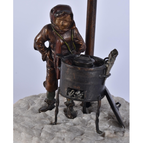 342 - AN EARLY 20TH CENTURY AUSTRIAN COLD PAINTED BRONZE LAMP formed as a boy beside a burning fire. 35 cm... 