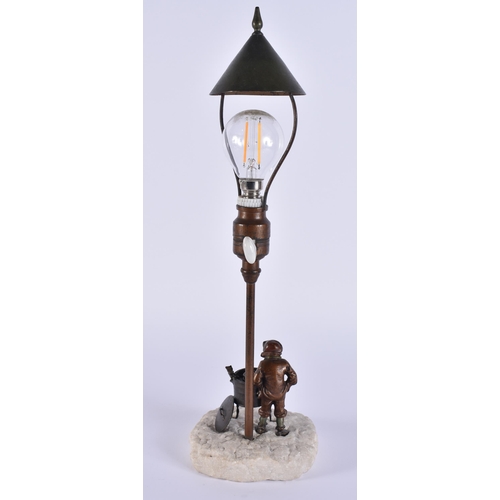 342 - AN EARLY 20TH CENTURY AUSTRIAN COLD PAINTED BRONZE LAMP formed as a boy beside a burning fire. 35 cm... 
