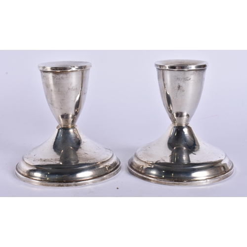 383 - A PAIR OF SILVER CANDLESTICKS. 360 grams overall. 9.5 cm high.