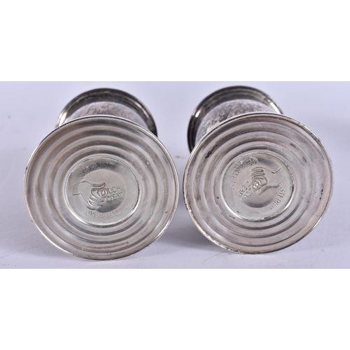 393 - A PAIR OF SILVER PEPPER POTS. 250 grams overall. 11 cm high.