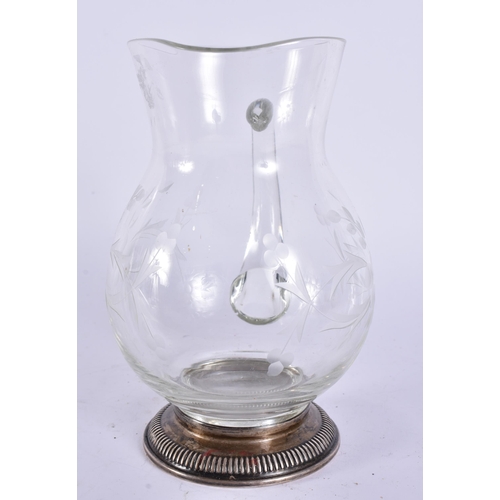 395 - A SILVER MOUNTED GLASS JUG. 17 cm high.