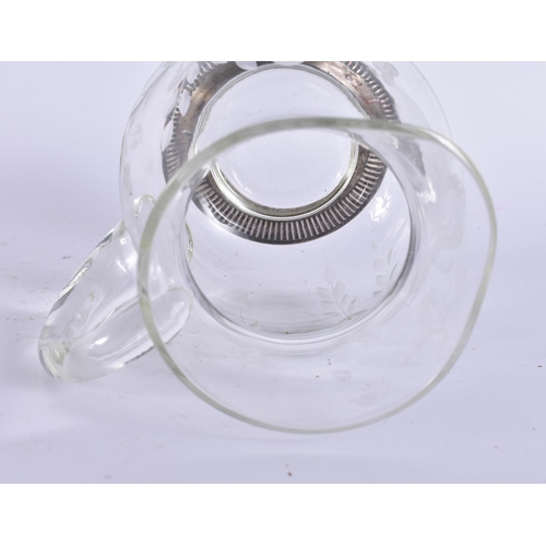 395 - A SILVER MOUNTED GLASS JUG. 17 cm high.