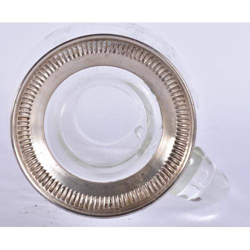 395 - A SILVER MOUNTED GLASS JUG. 17 cm high.