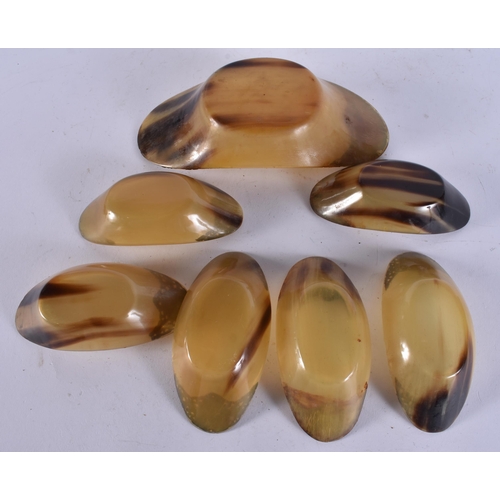 405 - A SET OF 19TH CENTURY INDIAN SILVER MOUNTED HORN BOWLS. Largest 18 cm wide. (7)