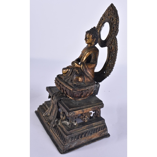 40D - AN 18TH/19TH CENTURY NEPALESE TIBETAN BRONZE BUDDHA modelled behind a flaming shrine. 22 cm x 10 cm.