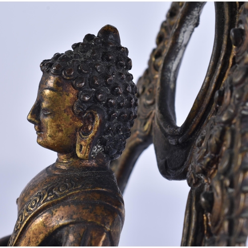 40D - AN 18TH/19TH CENTURY NEPALESE TIBETAN BRONZE BUDDHA modelled behind a flaming shrine. 22 cm x 10 cm.