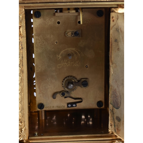 467 - A BRONZE RETICULATED CARRIAGE CLOCK. 19 cm high.