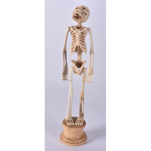 468 - A MEMENTO MORI CARVED STAG ANTLER SKELETON. 25 cm high.