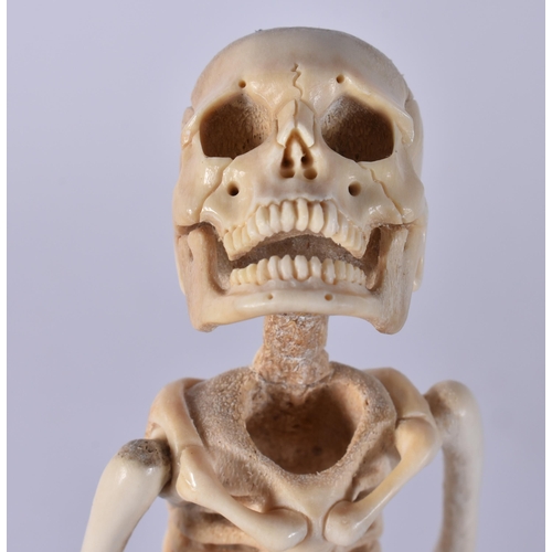 468 - A MEMENTO MORI CARVED STAG ANTLER SKELETON. 25 cm high.