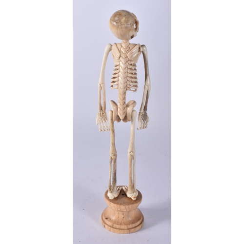 468 - A MEMENTO MORI CARVED STAG ANTLER SKELETON. 25 cm high.