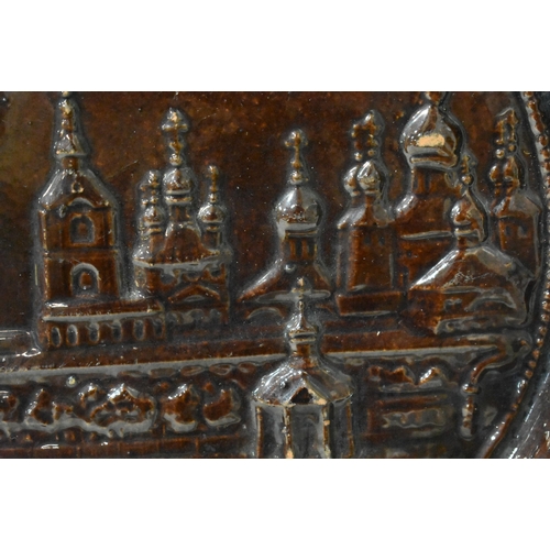 48 - AN EXTREMELY RARE ANTIQUE RUSSIAN TREACLE GLAZED POTTERY PLATE. 21.5 cm wide.