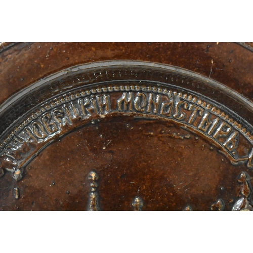 48 - AN EXTREMELY RARE ANTIQUE RUSSIAN TREACLE GLAZED POTTERY PLATE. 21.5 cm wide.