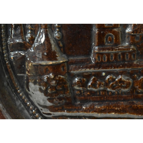 48 - AN EXTREMELY RARE ANTIQUE RUSSIAN TREACLE GLAZED POTTERY PLATE. 21.5 cm wide.