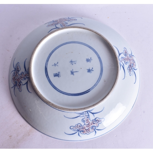 494 - A CHINESE BLUE AND WHITE IRON RED PAINTED BEAST DISH. 26 cm wide.