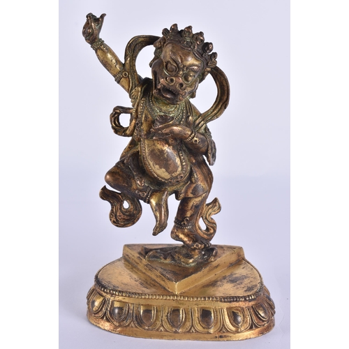 60D - AN 18TH/19TH CENTURY TIBETAN GILT BRONZE FIGURE OF A BUDDHIST DEITY modelled upon a triangular base ... 