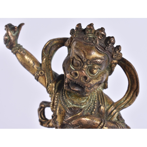 60D - AN 18TH/19TH CENTURY TIBETAN GILT BRONZE FIGURE OF A BUDDHIST DEITY modelled upon a triangular base ... 