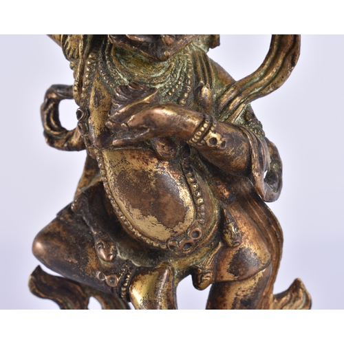 60D - AN 18TH/19TH CENTURY TIBETAN GILT BRONZE FIGURE OF A BUDDHIST DEITY modelled upon a triangular base ... 