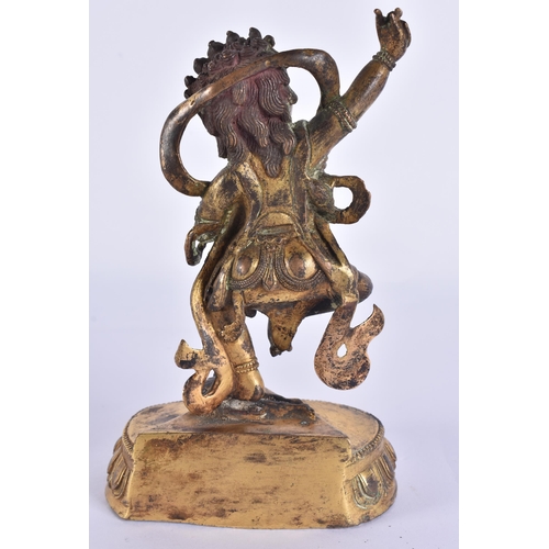 60D - AN 18TH/19TH CENTURY TIBETAN GILT BRONZE FIGURE OF A BUDDHIST DEITY modelled upon a triangular base ... 