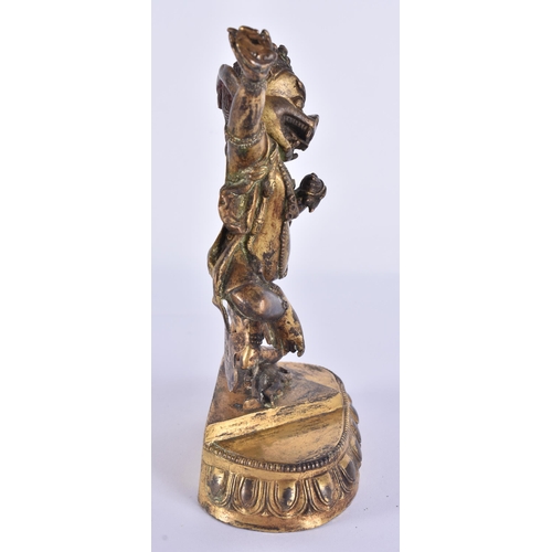 60D - AN 18TH/19TH CENTURY TIBETAN GILT BRONZE FIGURE OF A BUDDHIST DEITY modelled upon a triangular base ... 