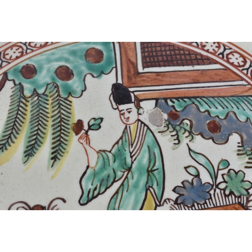 60E - A LATE 18TH/19TH CENTURY ENGLISH CREAMWARE SCALLOPED PLATE painted with an Oriental figure holding a... 