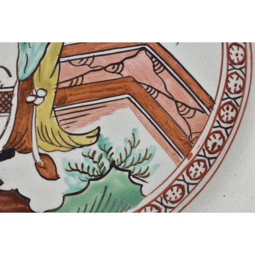 60E - A LATE 18TH/19TH CENTURY ENGLISH CREAMWARE SCALLOPED PLATE painted with an Oriental figure holding a... 
