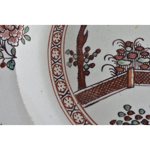 60E - A LATE 18TH/19TH CENTURY ENGLISH CREAMWARE SCALLOPED PLATE painted with an Oriental figure holding a... 