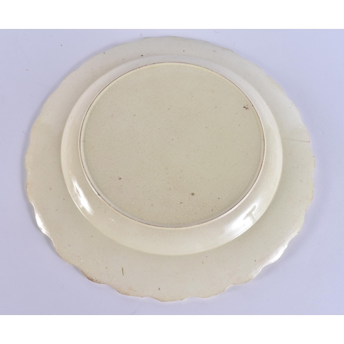 60E - A LATE 18TH/19TH CENTURY ENGLISH CREAMWARE SCALLOPED PLATE painted with an Oriental figure holding a... 