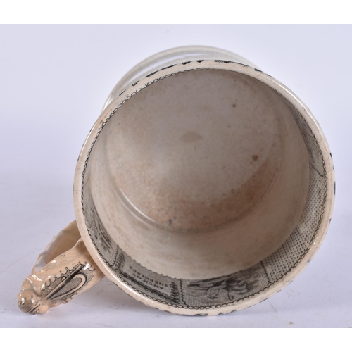 654 - A MID 19TH CENTURY ENGLISH BLACK AND WHITE POTTERY MUG. 15 cm wide.