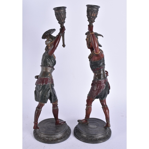 686 - A PAIR OF COLD PAINTED NATIVE AMERICAN FIGURAL CANDLESTICKS. 38 cm high.